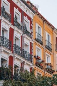 a red and white building with balconies and windows